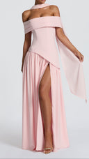 Woman in a blush Bardot-neckline maxi dress with matching scarf, styled for a wedding