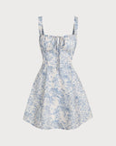 Woman wearing a blue floral corset mini dress with a ruched bodice