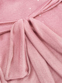 Woman wearing a pink tiered ruffle mini dress with a matching scarf