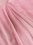 Woman wearing a pink tiered ruffle mini dress with a matching scarf