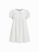 A white short-sleeve babydoll dress with a Peter Pan collar and ruffled trim, shown on a plain white background.
