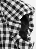 Woman wearing a black gingham mini dress with a twist-knot detail