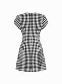 Woman wearing a black gingham mini dress with a twist-knot detail