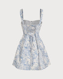 Woman wearing a blue floral corset mini dress with a ruched bodice