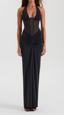 Woman wearing a black ruched maxi skirt, front view