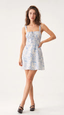 Woman wearing a blue floral corset mini dress with a ruched bodice