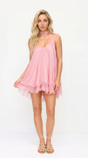 Woman wearing a pink dress on a white background