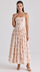 Woman wearing a blush floral corset midaxi dress