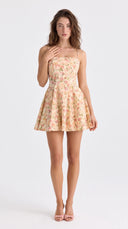 Woman wearing a yellow floral fit-and-flare mini dress