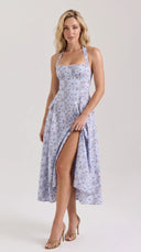 Woman wearing a blue floral halter midi dress with a button-front placket