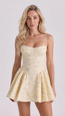 Woman wearing a lemon floral corset mini dress with a sweetheart neckline