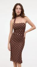 Woman wearing a chocolate polka dot midi dress with a halter choker neckline