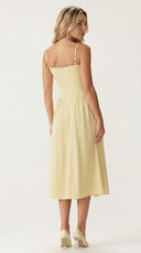 Woman wearing a light yellow dress on a white background