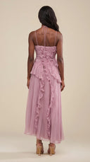 Woman wearing a dusty lilac asymmetric ruffle halter midi dress