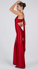 Woman wearing a red evening gown with cut-out design on a white background