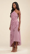 Woman wearing a dusty lilac asymmetric ruffle halter midi dress