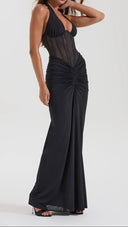 Woman wearing a black ruched maxi skirt styled with a matching top