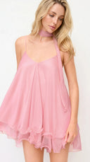 Woman wearing a pink dress against a white background