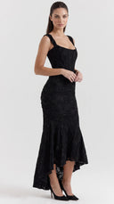 Woman wearing a black floral burnout fishtail midi dress
