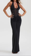 Woman wearing a black ruched maxi skirt, back view