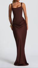 Odette plum brown pleated corset maxi dress, side view showing cowl overlay skirt
